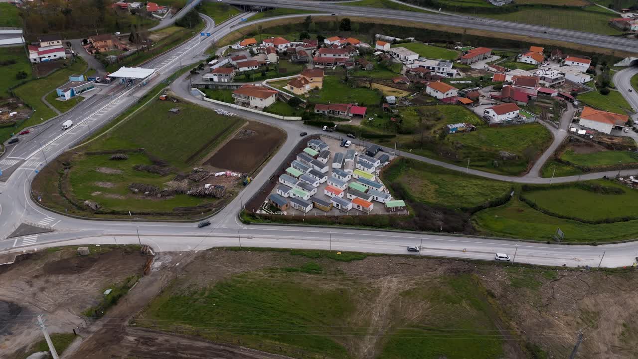 Aerial prefabricated house sample site beside village road in Portugal