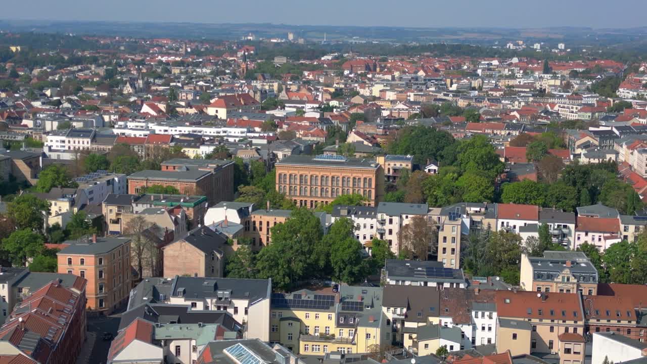 halle saale with the red brick building of the library surrounded by trees and houses, in germany. Fabulous aerial view flight drone shot footage from above