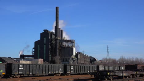 Global-warming-is-suggested-by-shots-of-a-steel-mill-belching-smoke-into-the-air-with-railcars-foreground-1