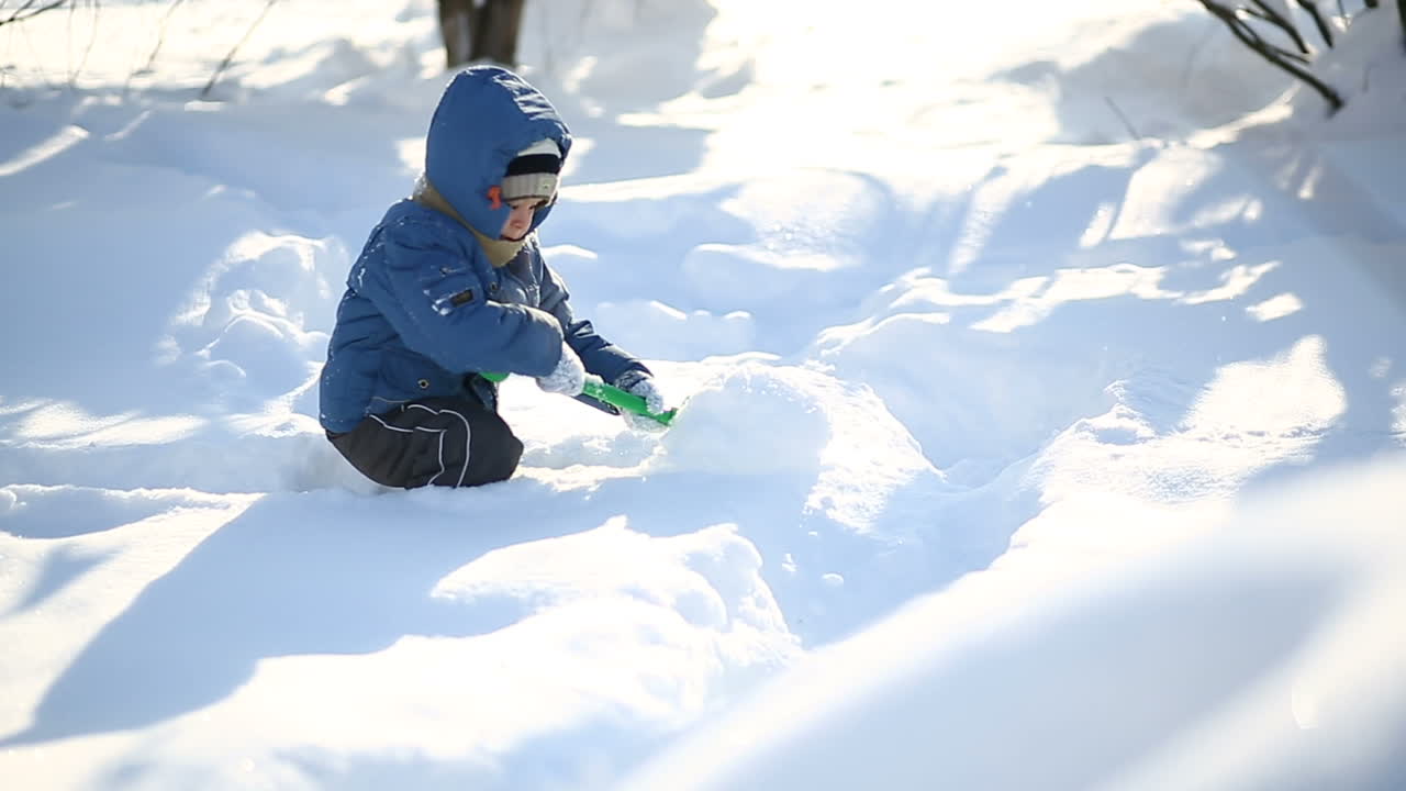 Boy with snow in winter. Little boy having fun with snow in winter day
