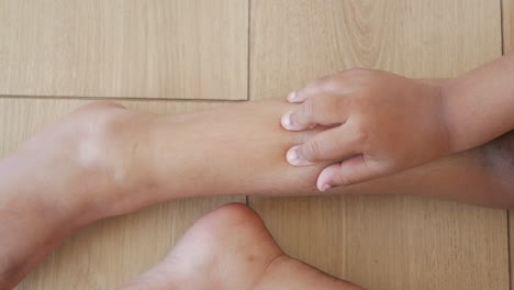 child scratching their leg