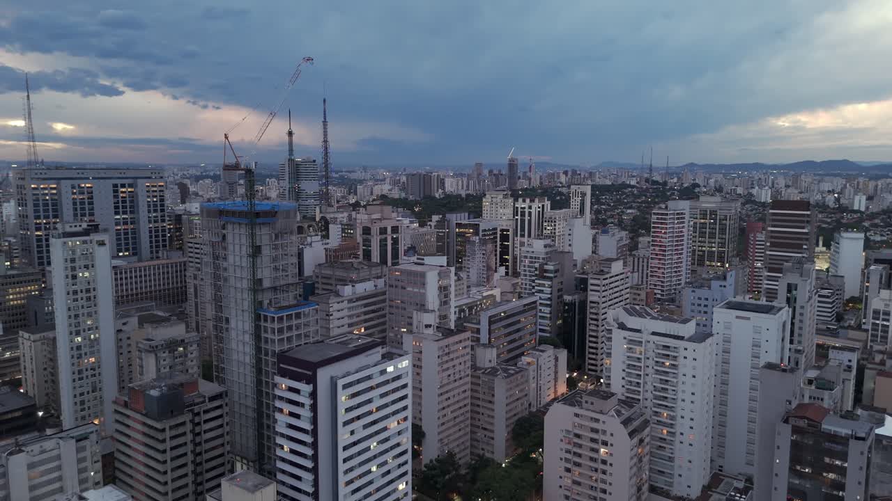 Sao Paulo City Skyline At Sunset With Dense Modern Buildings. - aerial shot