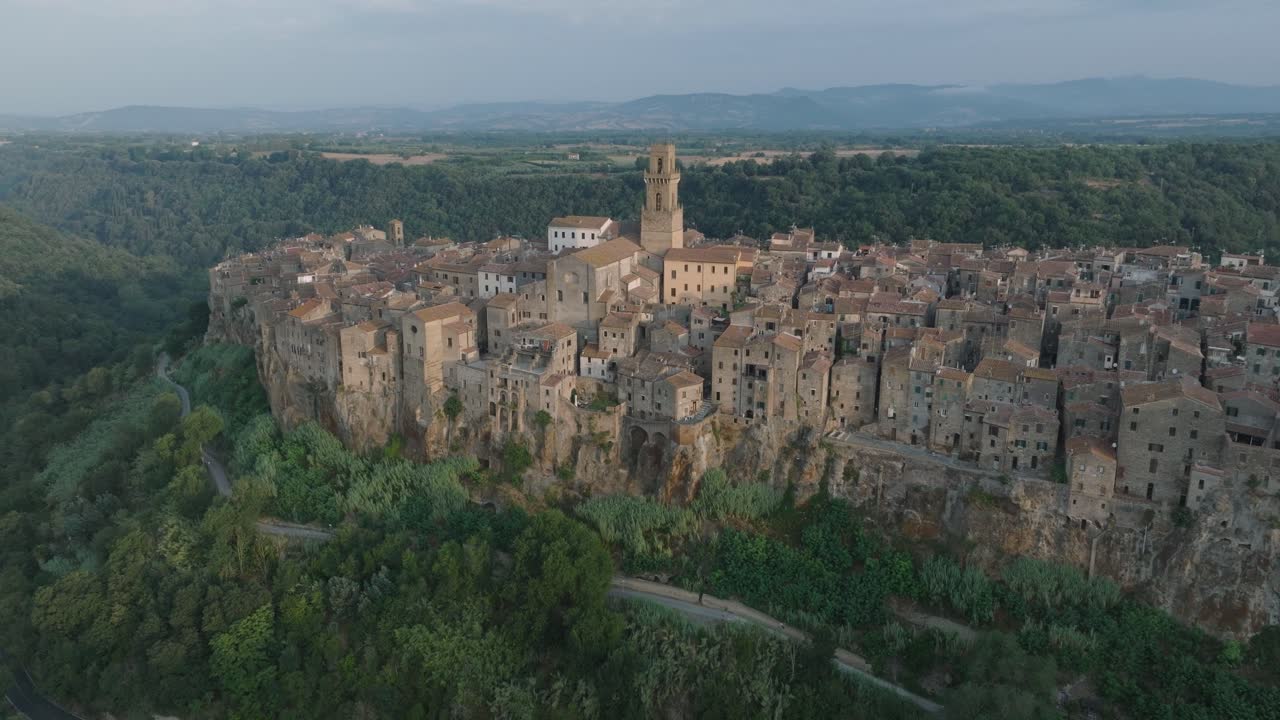 Aerial Drone view of the hilltop Medieval town of Pitigliano, Tuscany in morning light, with the Valdorcia and old buildings, in 4K