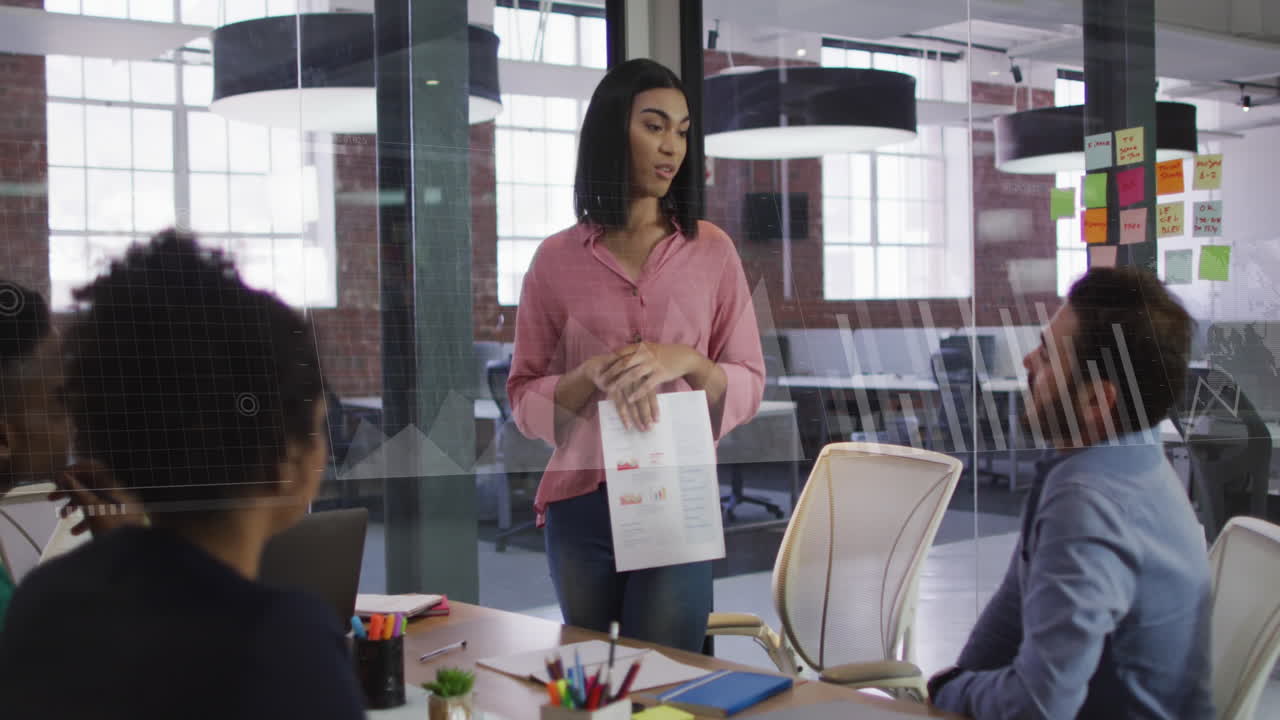 Animation of graphs, loading bars and map over diverse woman explaining reports to coworkers