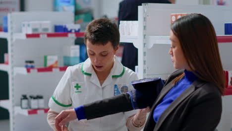 pharmacist using blood pressure gauge