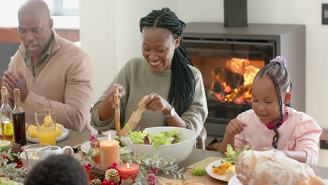 African-american-parents,-children-and-grandparents-celebrating-at-thanksgiving-dinner,-slow-motion