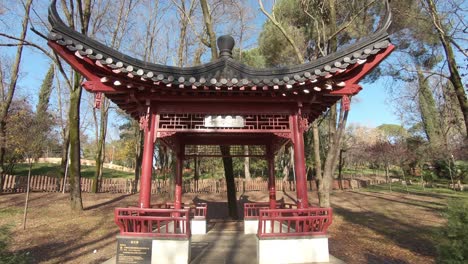 Beautiful-red-Chinese-pavilion-at-the-Artificial-Lake-national-park,-Tirana,-Albania