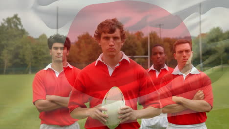 rugby players standing on field with japanese flag