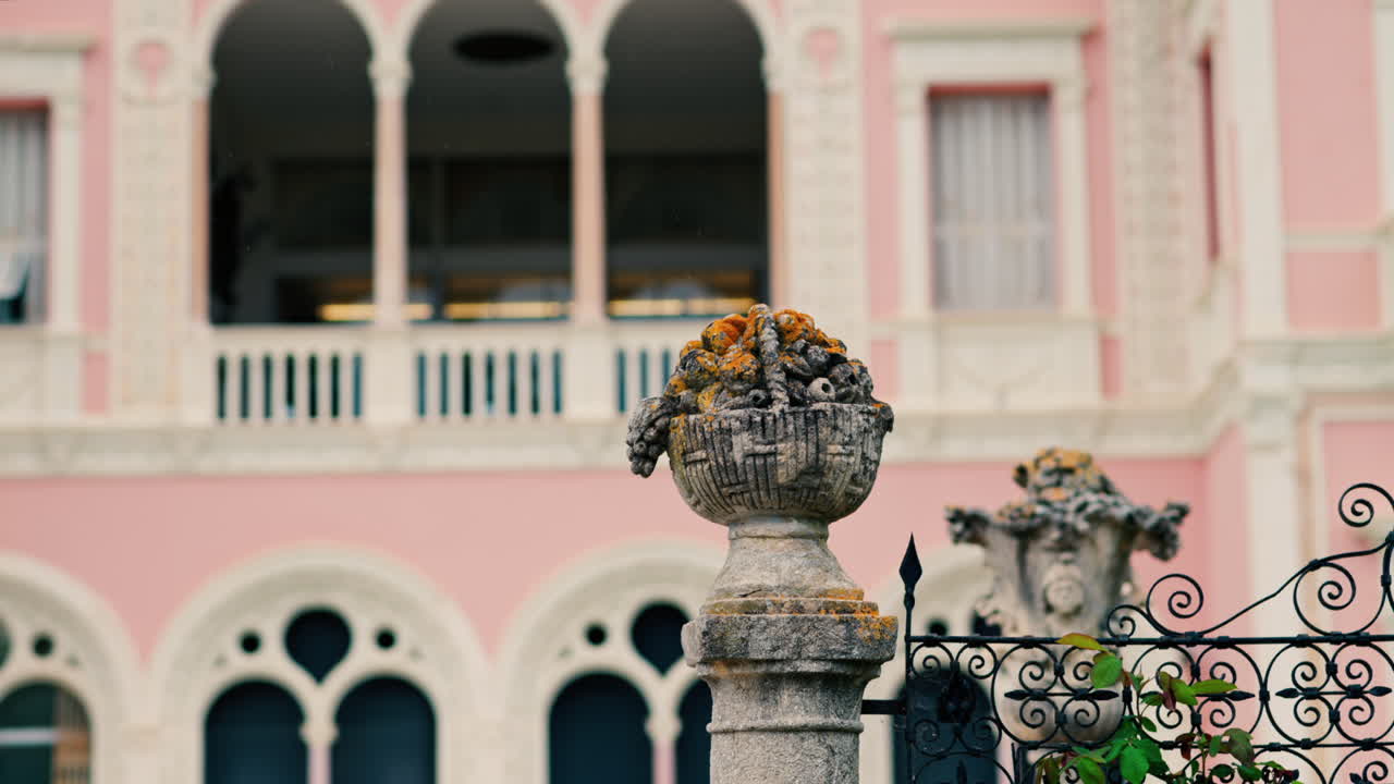 Close up of a decorative stone pillar in the courtyard of Villa Ephrussi de Rothschild with a blurred view on the background