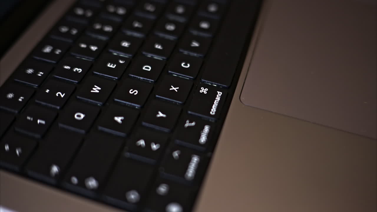 Close up black notebook keyboard with illuminated buttons