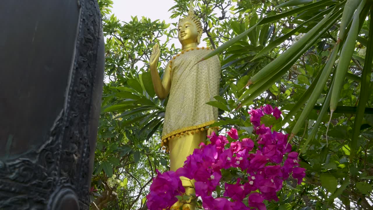 Slow motion cinematic slider over golden Buddha Statue in Japan