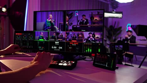 hands operating video production equipment in a live streaming studio