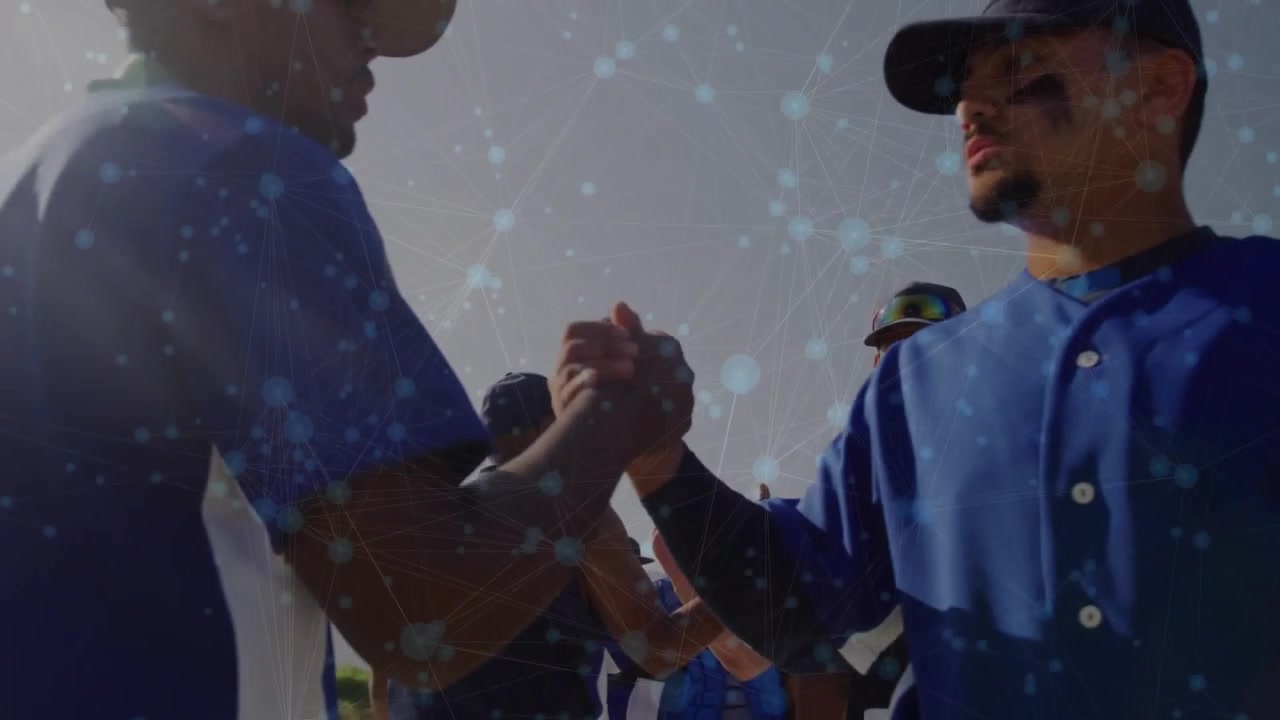 Baseball players postgame navy player initiating handshake and fist bump showing sportsmanship