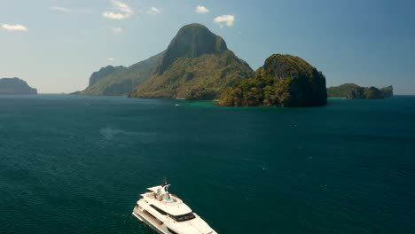 Aerial-flying-over-big-yacht-showing-Cadlao-Island,-El-Nido,-Palawan,-Pilippines