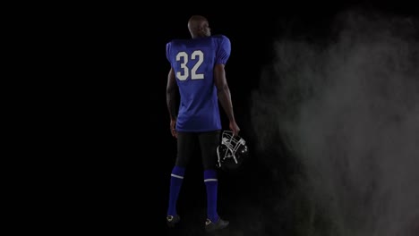 Animation-of-colourful-powders-over-american-football-player