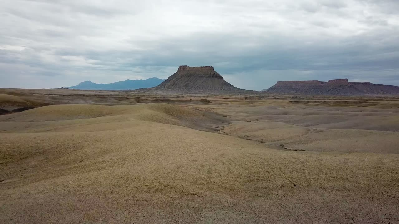 Dramatic Aerial View of Utah Desert and Factory Butte Rock Formation Under Cloudy Sky. USA
