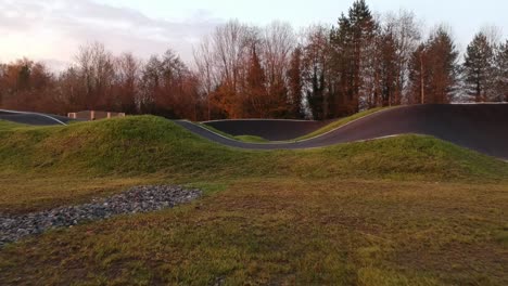 eboarder riding around a bmx pump track