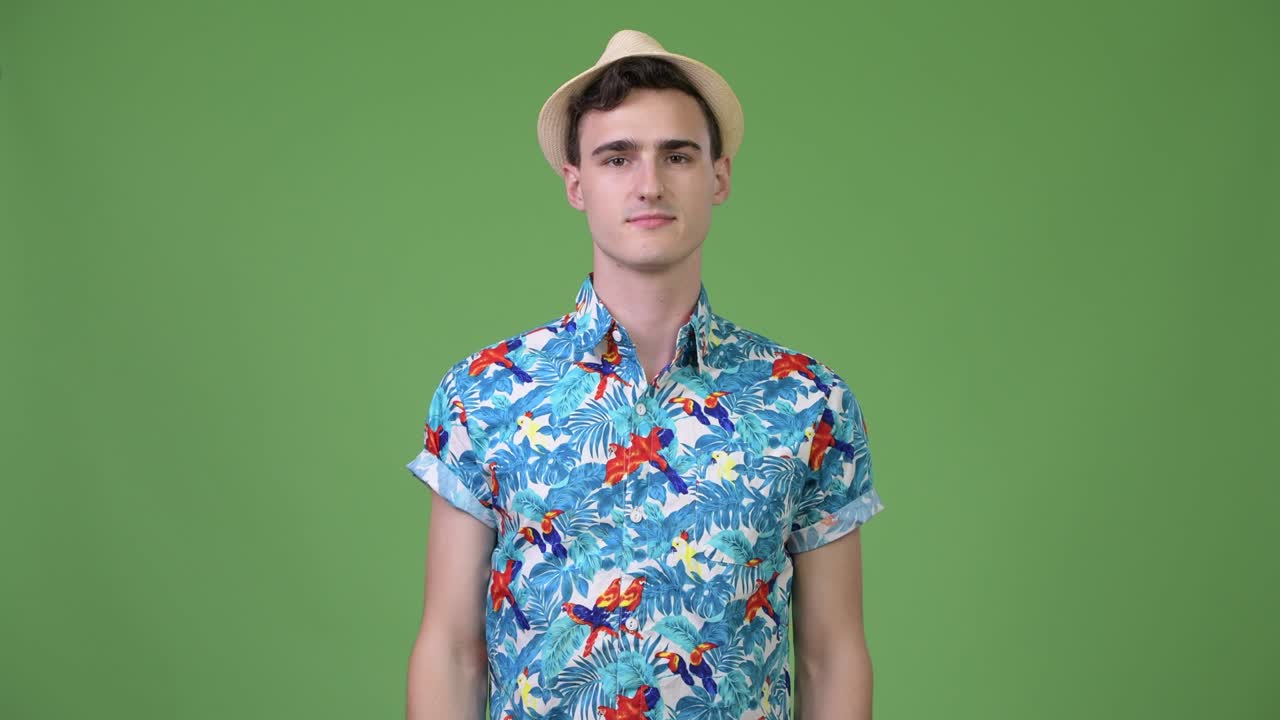 Young handsome tourist man pointing finger up