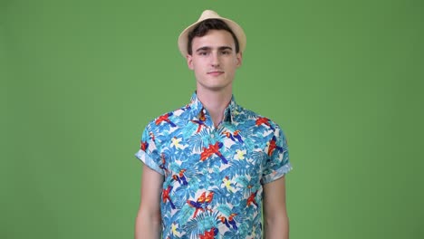 young handsome tourist man pointing finger up