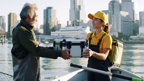 a friendly exchange on the water: an enthusiastic young woman and experienced fisherman share a moment while fishing in the cityscape