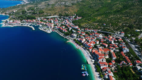 aerial view tilting over the podgora village in sunny makarska riviera, croatia