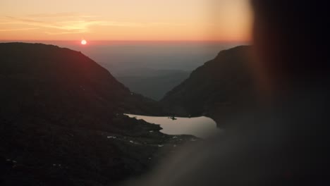 girl enjoys an epic sunset in the mountains