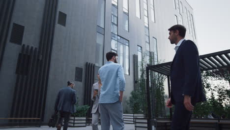 Focused-man-talking-mobile-phone-at-corporate-office-center.-Downtown-area.