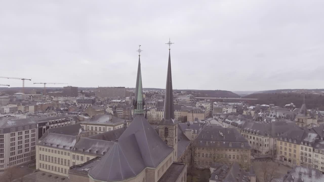 Aerial over church and cityscape establishing of downtown Luxembourg City