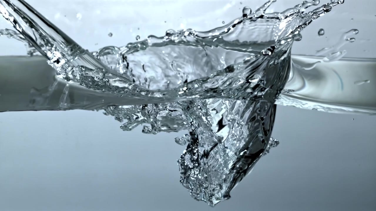 Clear Water Pouring and Splashing into a Container