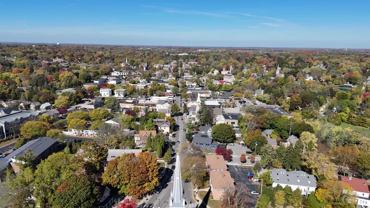 Slow cinematic aerial view of downtown Cedarburg WI featuring the steeple of St. Francis Borgia - South Church