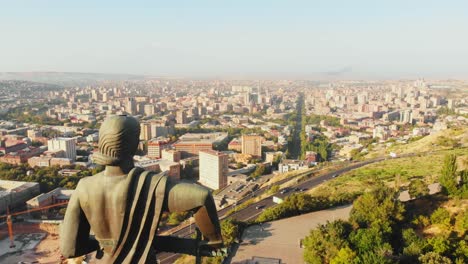 yerevan, armenia - 2nd september, 2021: the statue of mother armenia. mother armenia monument aerial close circular view. in background street, buildings victory park in yerevan