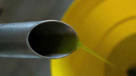 olive oil being produced from machine