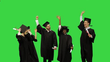 young happy people at the graduation ceremony, group high five on a green screen, chroma key