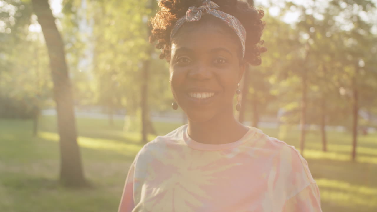 Portrait of Joyous African American  Woman Outdoors on Sunny Day
