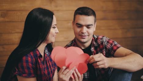 enamored are counting the number of hearts handmade from colored paper on the bed on valentine's day