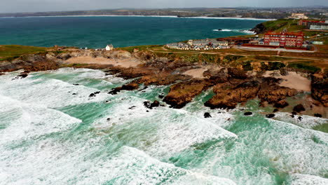 aerial drone shot over the sandy beach in newquay, cornwall, united kingdom