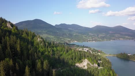 Aerial-Panning-Shot-of-lake-with-mountain-range-in-the-background