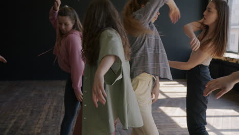 teenage girls practicing dance moves in a studio