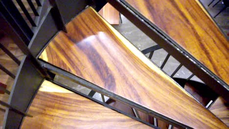 Shot of a person ascending the spiral staircase inside Museo de Arte Moderno Cuernavaca surrounded by bookshelves