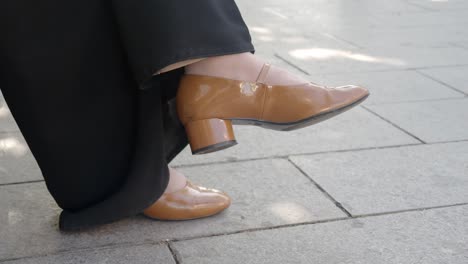 woman's feet in brown high heels