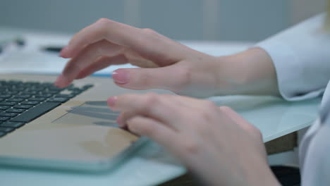 Woman-doctor-working-on-laptop.-Working-hands-typing-laptop-keyboard