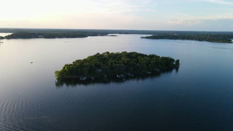 aerial view of lonely island in the middle of a lake during summer time