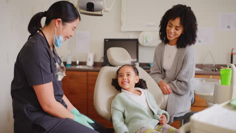 Dentist-and-child-giving-high-five-during-fun