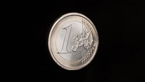 isolated italian 1 euro coin rotating on black background