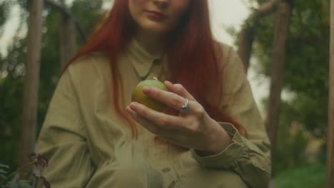 woman eating an apple in a garden
