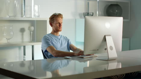 corporate worker looking computer screen at home. it manager typing keyboard.