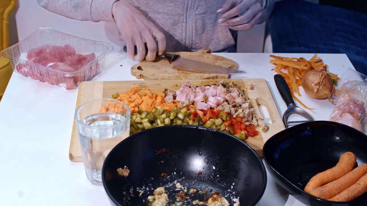 Woman prepares soup ingredients by chopping potatoes meat and veggies fast, 4k