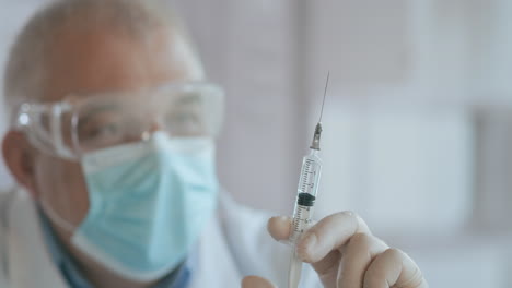 doctor preparing syringe. doctor preparing syringe for injection. female doctor or nurse holding syringe with liquid close up. medicine and vaccination. high quality 4k footage