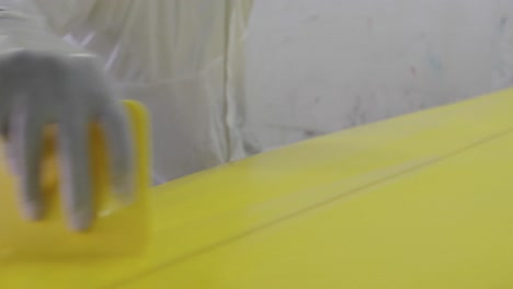 male surfboard maker in his workshop