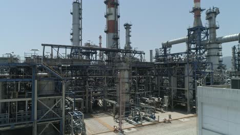 Aerial-footage-of-a-large-scale-Oil-refinery-with-smoke-stacks-and-petroleum-storage-tanks